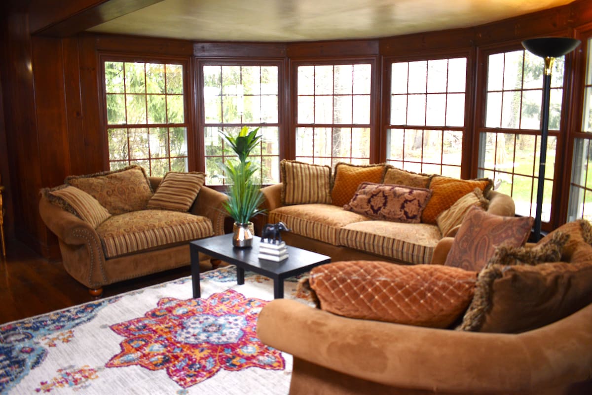 Wood-paneled sitting room pictured in an Acadia Farms rental listing